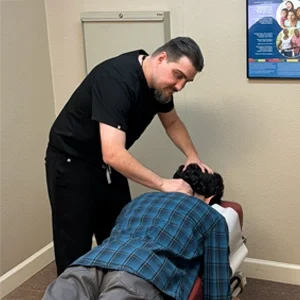 Dr. Brian Long performing a cervical adjustment to support spinal alignment and mobility.